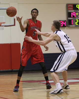 Findlay Prep’s Christian Wood (5) pass the ball while being guarded by the Impact Acad ...
