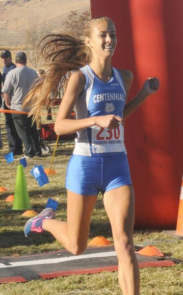 Sydney Badger of Centennial High School smiles as she crosses the finish line to win the Div ...