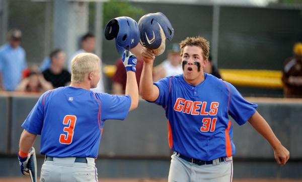 Bishop Gorman’s Nick Gates, right, celebrates a home run with teammate Matt Hudgins.