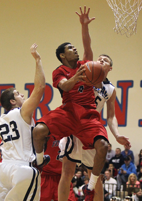 Findlay Prep’s Allerick Freeman (4) drives to the basket while being guarded by the Im ...