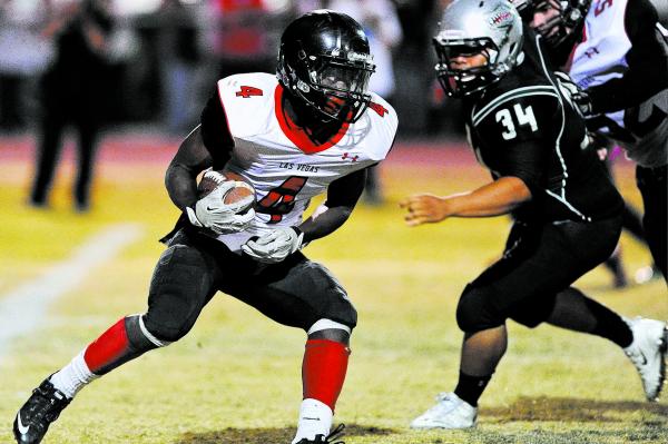 Las Vegas running back Elias Miller (4) looks for running room in front of Green Valley&#821 ...