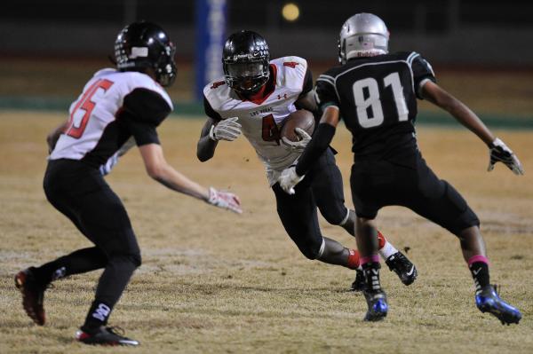 Las Vegas running back Elias Miller (4) looks for running room against Green Valley’s ...