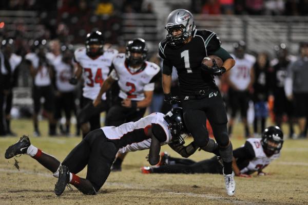 Green Valley wide receiver Giovanni Hernandez, sidestepping Las Vegas linebacker Elias Mille ...