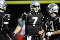 Green Valley quarterback Christian Lopez (7) receives congratulations from Conor Perkins, le ...