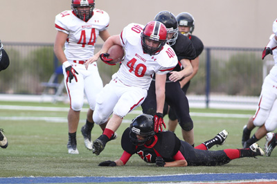 Pershing County football player Jared Jensen (40) steps over Mountain View’s T.J. Kiss ...