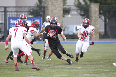 Mountain View football player Travis Wallis (15) runs past Pershing County’s defense a ...