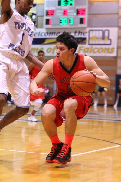 Las Vegas’ Roberto Zavala (5) looks to drive past Foothill’s Jalen Shepard (1) o ...