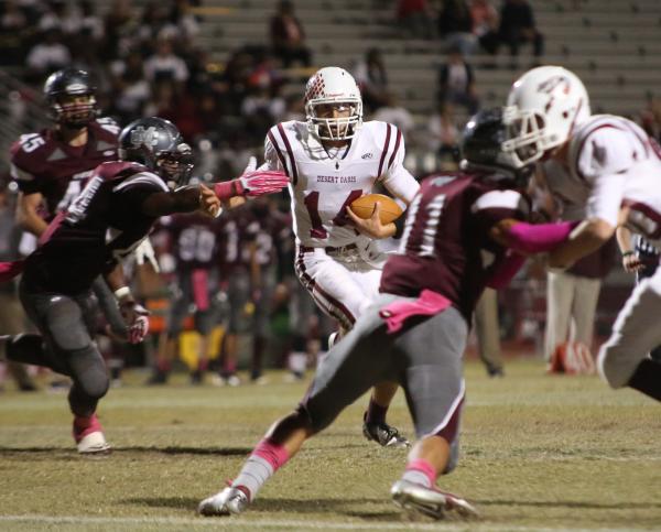 Desert Oasis quarter back Richie Stammetti carries the ball in the first quarter on Friday n ...