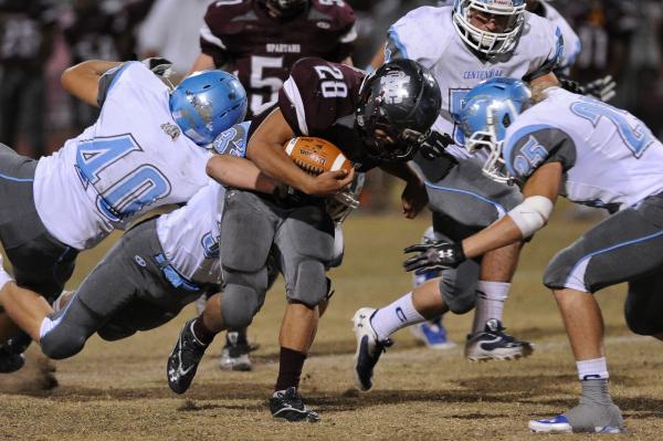 Cimarron’s Michael Barnson (28) runs into Centennial’s Austin Schulter (25) on T ...