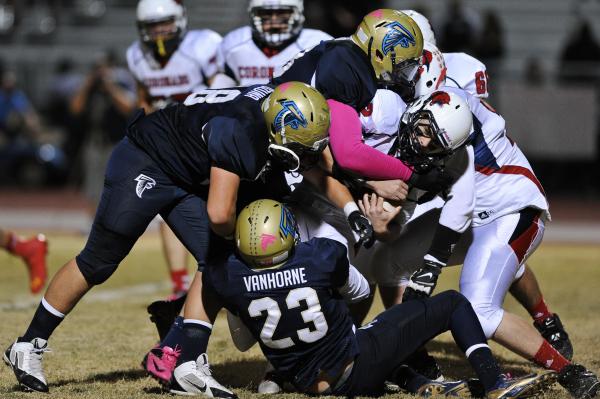 Coronado’s Jackson Cofer (12) is brought down by a host of Foothill defenders on Frida ...