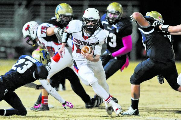 Coronado’s Jackson Cofer (12) finds running room between Foothill defenders on Friday. ...