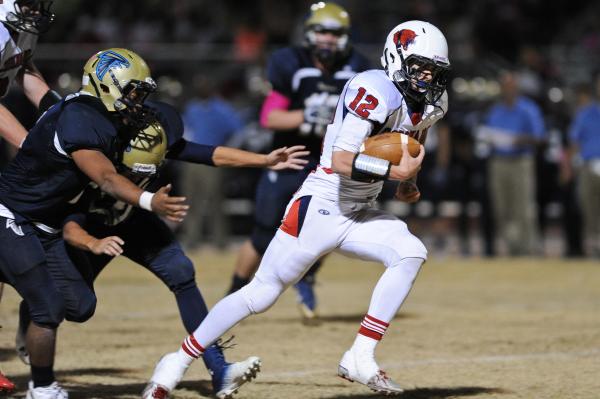 Coronado’s Jackson Cofer (12) breaks away from Foothill defenders to score one of his ...