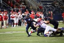 Bishop Gorman running back Russell Booze fights for extra yardage on Friday night. Booze had ...