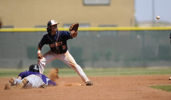 Legacy’s Joey Ingarra takes a throw as Durango’s Scott Martinez dives into secon ...