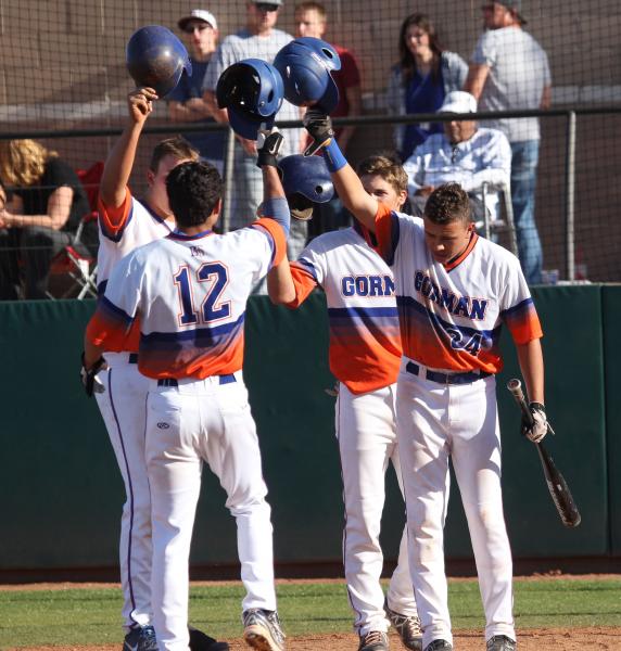 Kenny Meimerstorf (12) is greeted by Bishop Gorman teammates, from left, Nick Gates, Cole Kr ...