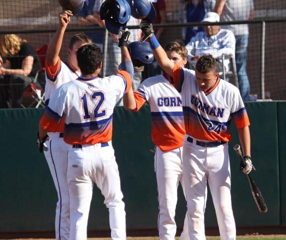 Kenny Meimerstorf (12) is greeted by Bishop Gorman teammates, from left, Nick Gates, Cole Kr ...