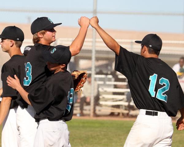 Silverado senior pitcher David Kuzma, left, fist-bumps senior teammate Thomas Licea after th ...