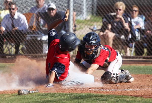 Coronado’s Carmen DiGennaro slides in under the tag of Liberty catcher Joe Maurer to s ...