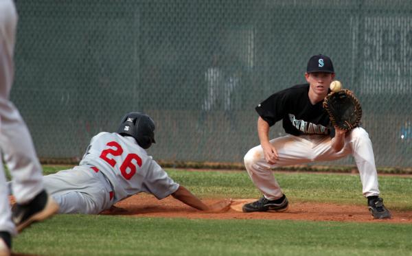 Silverado first baseman Michael Camburn concentrates on the throw as Las Vegas’ Hector ...