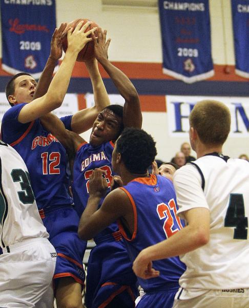 Gorman’s Zach Collins (12) and Nick Blair (23) both grab a rebound as teammate Deon Wh ...