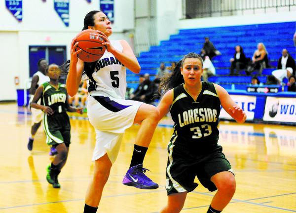 Durango basketball player Jazmin Chavez (5), center, goes in for a layup against Kianna Will ...