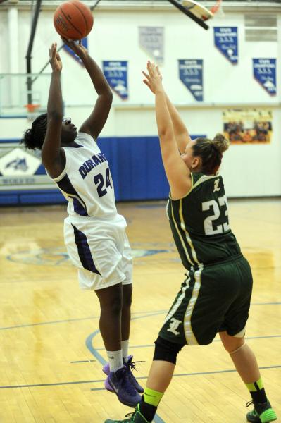 Durango basketball player Vonie Thomas (24), left, shoot the basketball against Victoria Sos ...