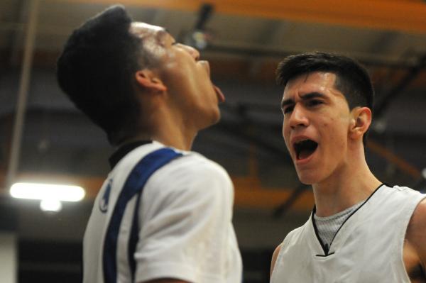 Canyon Springs’ Jordan Davis (3) takes a shot over Desert Pines’ Kevin Butler (3 ...