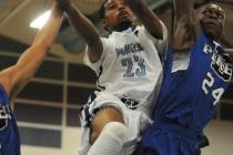 Canyon Springs guard Shaquile Carr (23) tries to score around Desert Pines forward ...