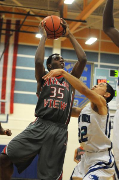 Chaparral’s Tyree McNeal (35), center, drives the ball to the basket on Monday against ...