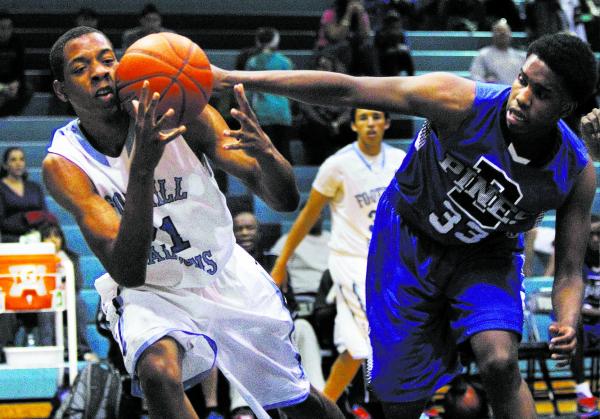 Foothill’s Torrance Littles (21) fights for a loose ball against Desert Pines’ T ...