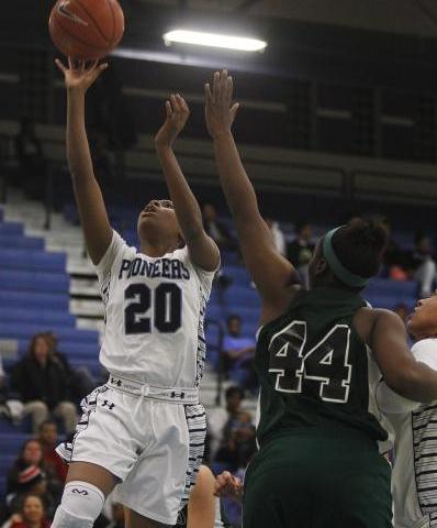 Canyon Springs’ Alexia Thrower (20) goes in for a layup past Rancho’s LaKissa Ma ...