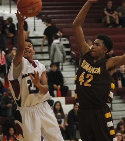 Desert Oasis’ Rodrick Moore (23) shoots past Bonanza’s Davian Jordan (42) on Fri ...