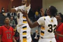 Clark’s Diontae Jones (24) grabs a rebound in front of Las Vegas’ Devon Colley ( ...