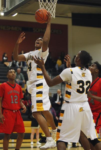 Clark’s Diontae Jones (24) grabs a rebound in front of Las Vegas’ Devon Colley ( ...