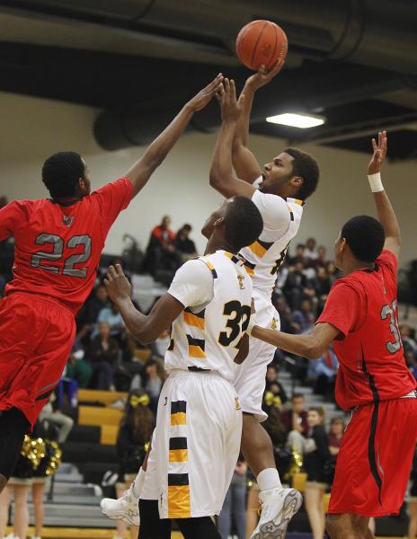 Clark’s Ty’Rek Wells (13) shoots over Las Vegas’ Patrick Savoy (22) on Fri ...