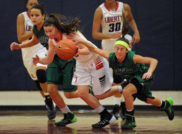 Green Valley’s Maggie Manwarren, right, attempts to stop Liberty’s Kealy Brown o ...