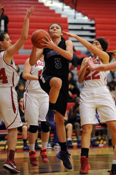 Durango’s Jazmin Chavez (5) lays up the ball between Arbor View’s Amanda Embleto ...