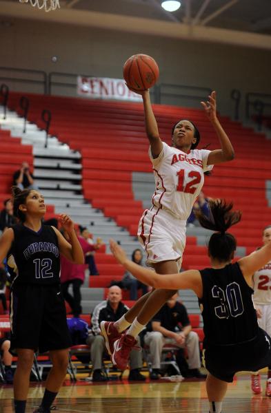 Arbor View’s Ariona Gill (12) takes a shot between Durango’s Maria Rico, left, a ...