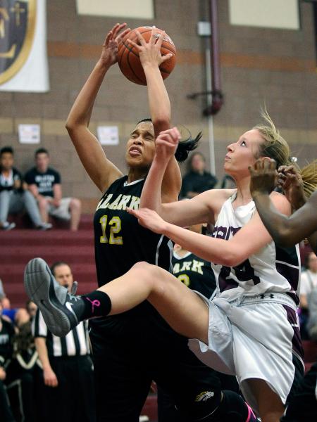 Clark’s Bobbi Floyd (12), grabs a rebound over Faith Lutheran’s Morgan Hill on T ...