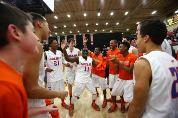 Bishop Gorman players, led by Obim Okeke (11) celebrate their 76-72 overtime win over Findla ...