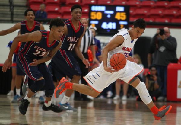 Bishop Gorman’s Richie Thornton, right, tries to elude Findlay Prep’s Justin Jac ...