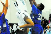 Canyon Springs’ Jordan Davis (3) takes a shot against Desert Pines Jordan Simon (32), ...