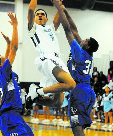 Canyon Springs’ Jordan Davis (3) takes a shot against Desert Pines Jordan Simon (32), ...