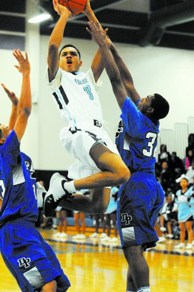 Canyon Springs’ Jordan Davis (3) takes a shot against Desert Pines Jordan Simon (32), ...