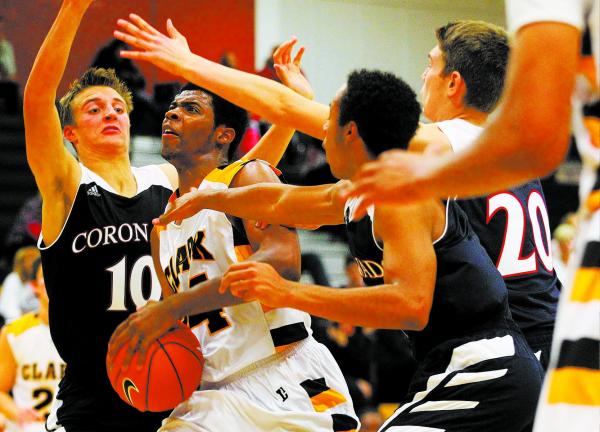 Clark’s Diontae Jones (24) looks to shoot as Coronado’s Travis Boman (10), Nick ...