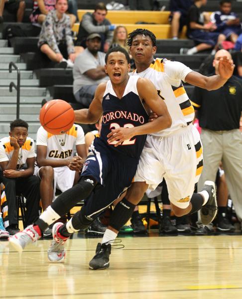 Coronado’s Eddie Austin (22) drives past Clark’s Darius Jackson (44) on Monday. ...