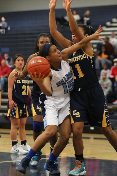 Centennial’s Alex Dockery (15) tries to shoot over El Segundo’s Jordan Swanier ( ...