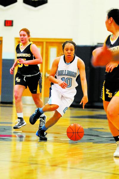 Centennial guard Tramina Jordan weaves between El Segundo (Calif.) defenders on Friday. Jord ...