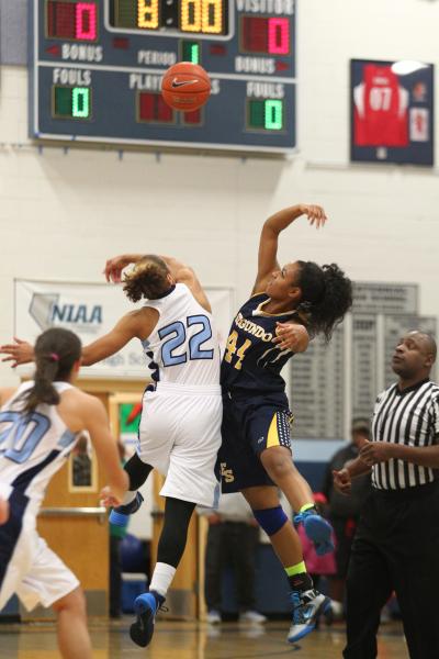 Centennial’s Teirra Hicks (22) and El Segundo’s Myia Mosley (44) go for the open ...