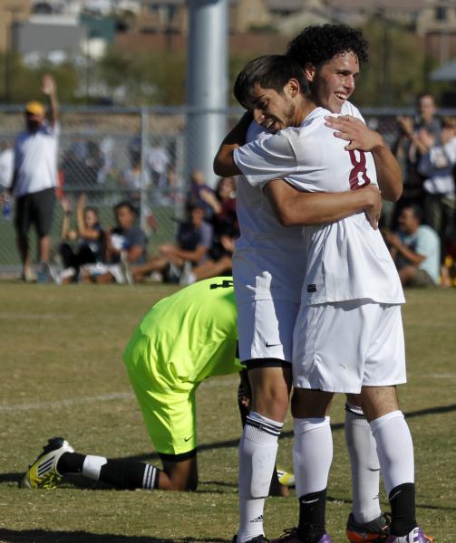 Eldorado’s Andres Lua (20) and Chris Perez (8) embrace after combining for a second-ha ...